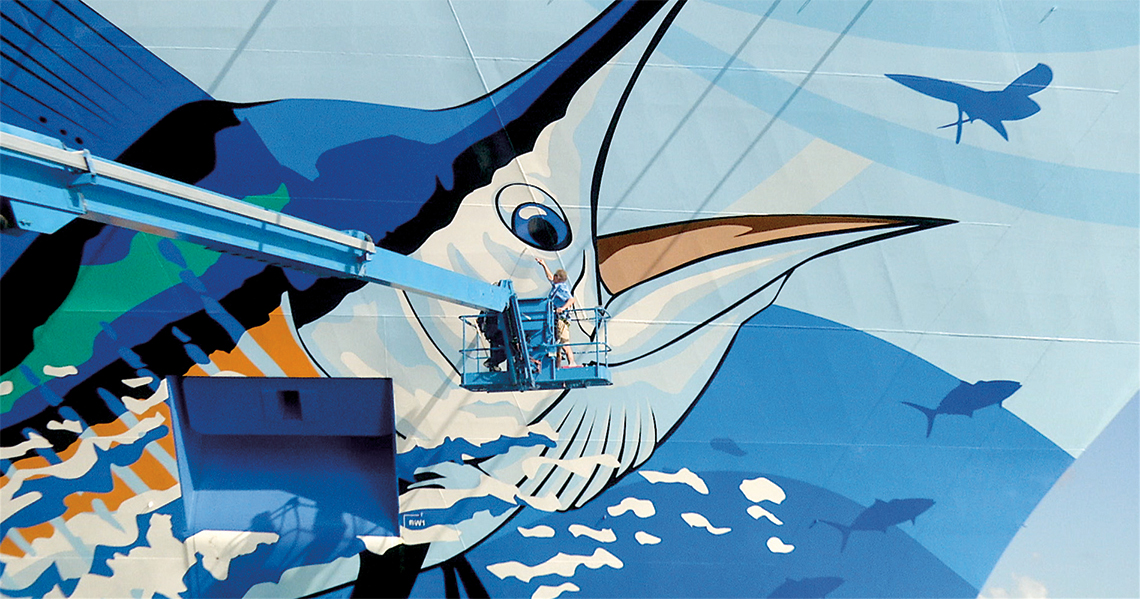 Painting the hull of Norwegian Cruise Lines' <em> Norwegian Escape </em>.