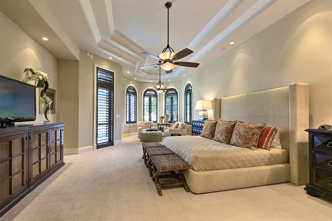 Master suite features plantation shutters, his –and-hers walk-in closet, a morning bar, and an outside entry to the pool area. Photography: Coldwell Banker Residential Real Estate.