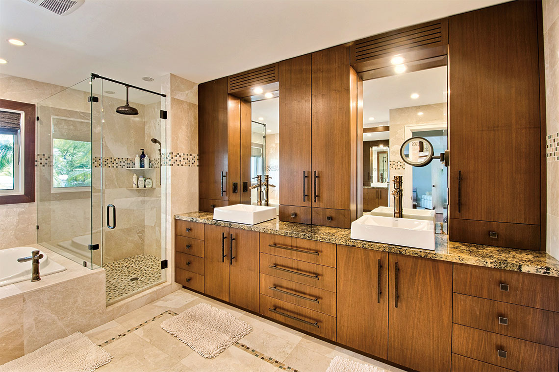 The master bath includes his-and-hers sinks, a glass shower with a rainforest showerhead and a spacious tub. Photography: Barkin-Gilman & Associates, Coldwell Banker Global Luxury.