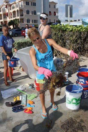 Lisa Miceli and volunteers from SOS Ocean Clean Up collect trash. <em>Photography: Lisa Miceli.</em>