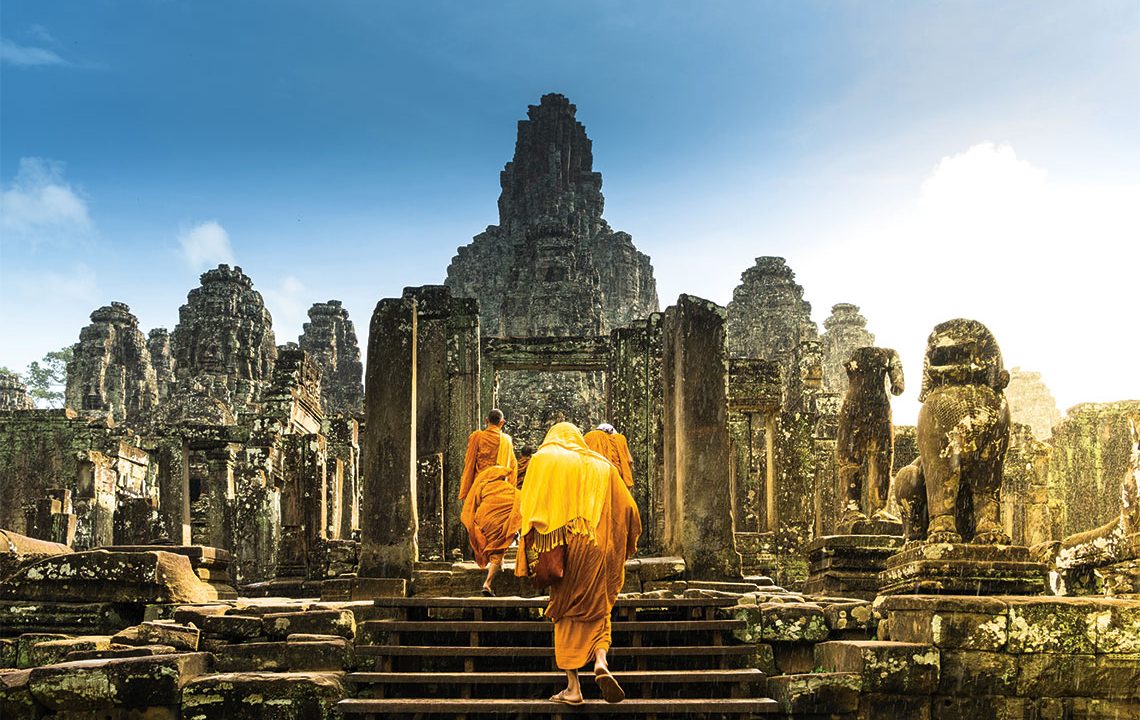 Monks at the Bayon temple of Angkor. Photography: Shutterstock / Tamvisut.