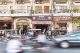Tuk-tuks and cars rush in front of caefs and hotels on the main road along the Mekong River. Photography: Shutterstock / AsiaTravel.