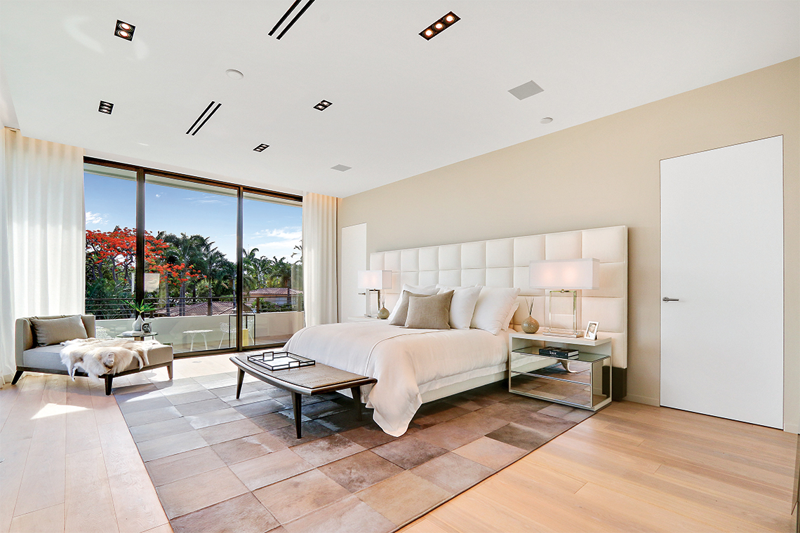 The master bedroom is just steps away from the wraparound terrace overlooking the backyard & water. Photography: LauderdaleONE Luxury Real Estate