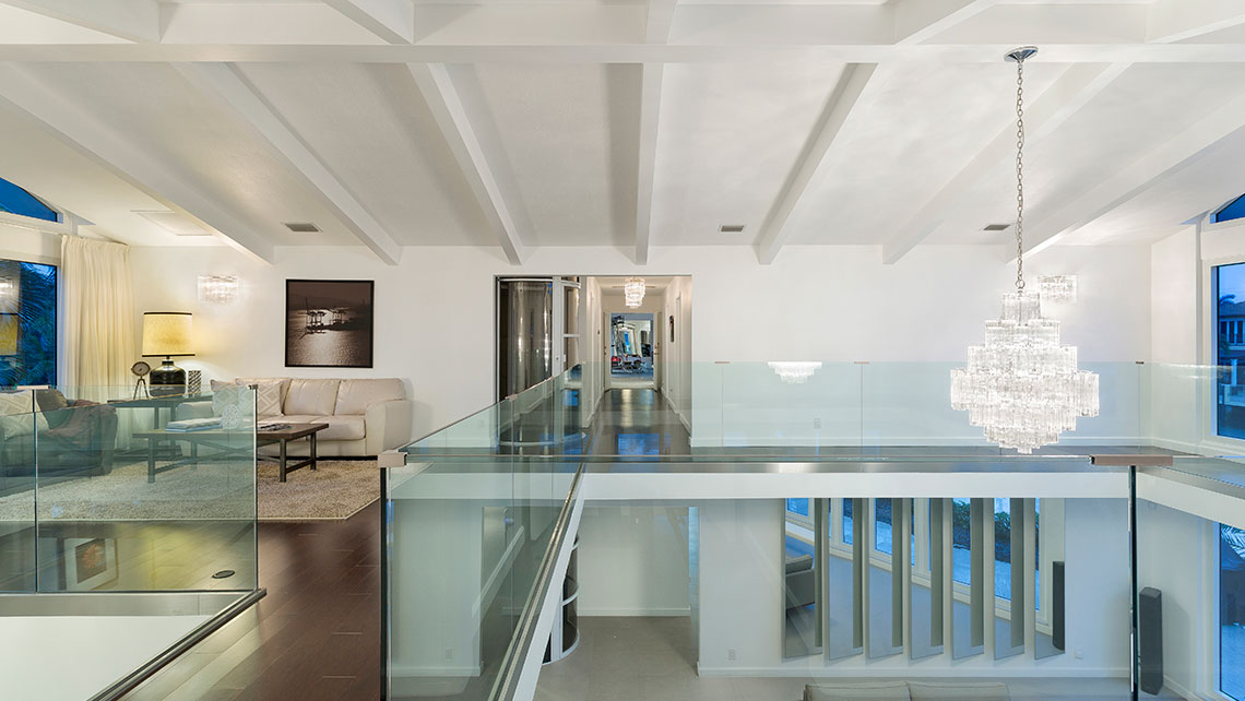 The glass-lined balcony allows for uninterrupted waterfront views from the living room.