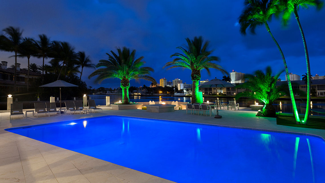 IBI Designs Boca Raton.In the evening, palm trees light up in green.