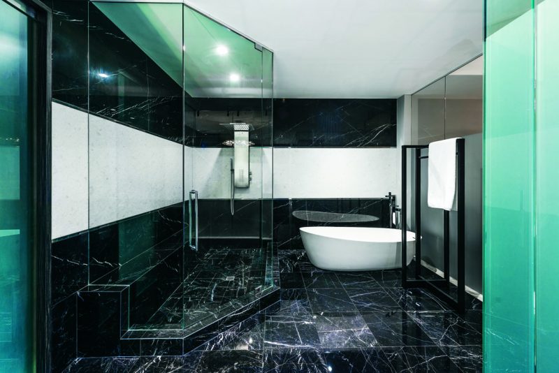 The newly renovated master bath features a freestanding tub upgraded to Porcelanosa almond-shaped Krion tub with a new floor-mounted tub filler. Photography: John Paul Nadeau.