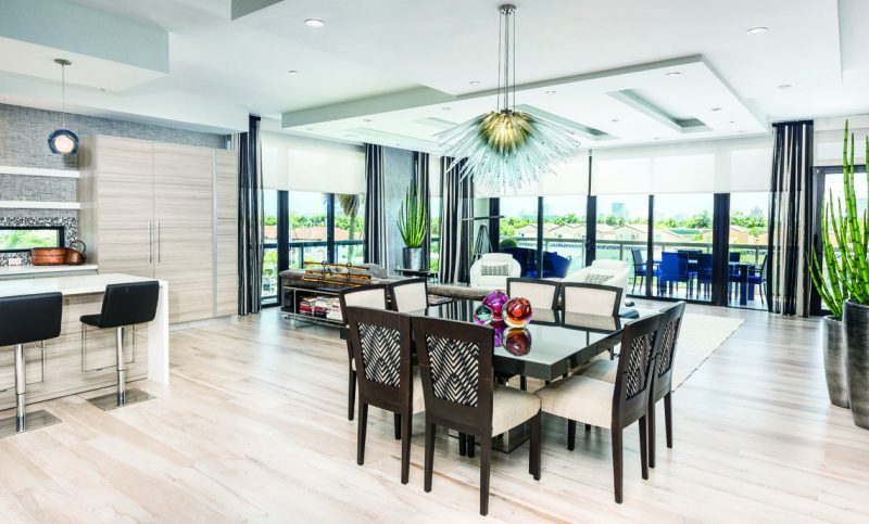 A large eight-seater square dining table was selected with a thick black absolute granite top with a polished steel square base and custom upholstered seating. Photography: John Paul Nadeau.