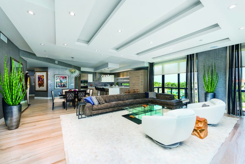 Furnishings include a large full-grain upgraded leather sectional in a greige tone with natural hide coverings for area rugs. Photography: John Paul Nadeau.