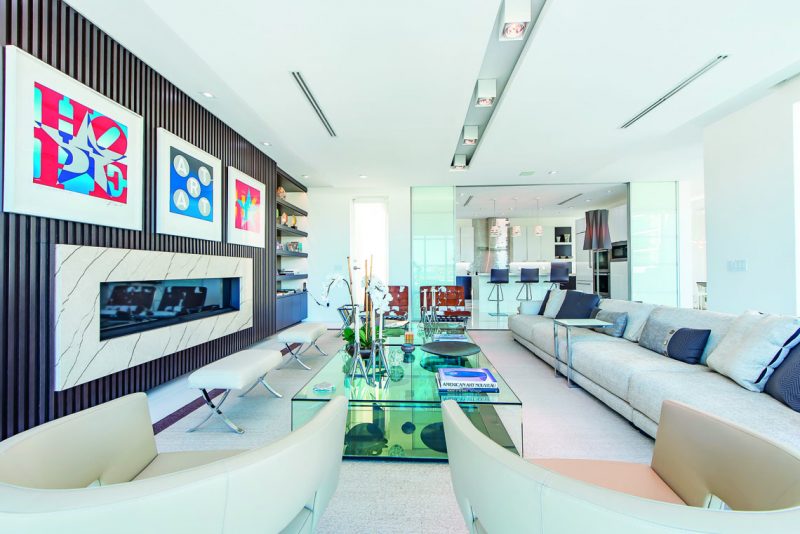 The main living area, located on the second floor, features an eight-foot-long fireplace. Photography by Eric Igualada, Spectrum Aerial Video & Photography