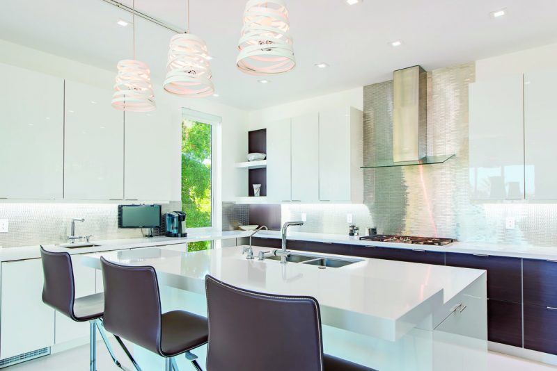 The kitchen, also located on the second floor, includes a wine cooler and refrigerator and freezer drawers. Photography by Eric Igualada, Spectrum Aerial Video & Photography