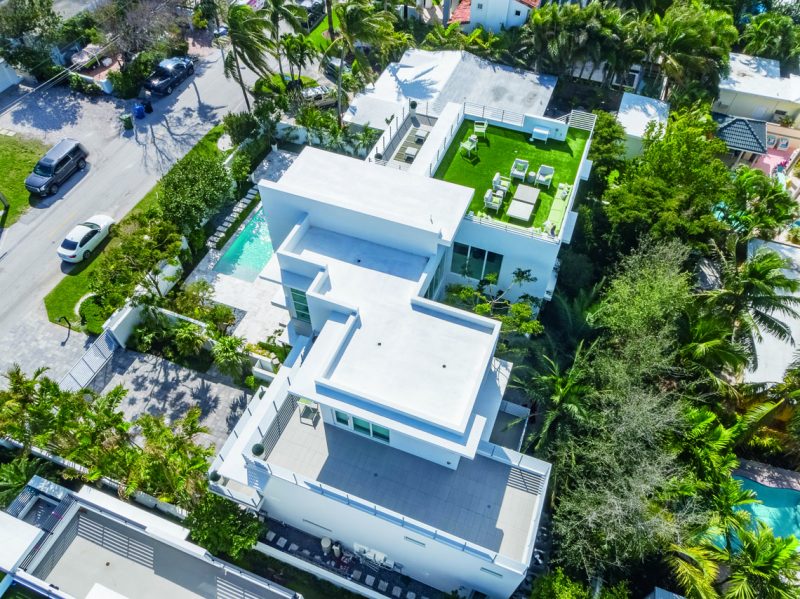 The rooftop lounging area is equipped with concrete furniture. Photography by Eric Igualada, Spectrum Aerial Video & Photography
